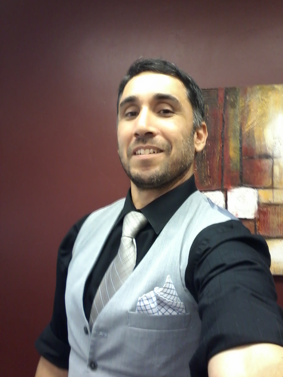 Daniel Bermudez, founder of Raster Digital, in a gray vest and tie